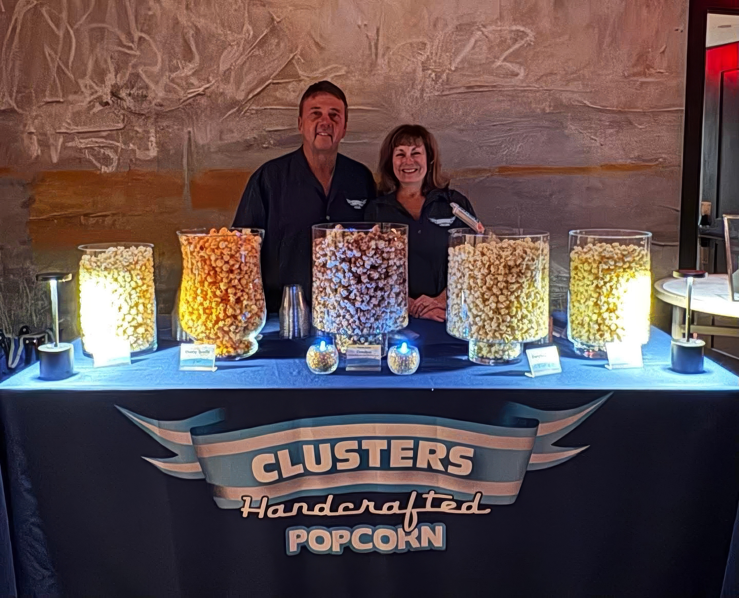 CLUSTERS owners behind the popcorn bar